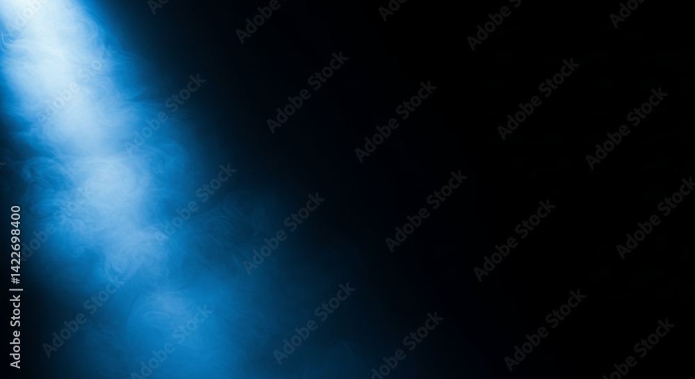 Fototapeta premium Soft blue light beam illuminating swirling mist against a dark background, creating a mysterious and ethereal atmosphere