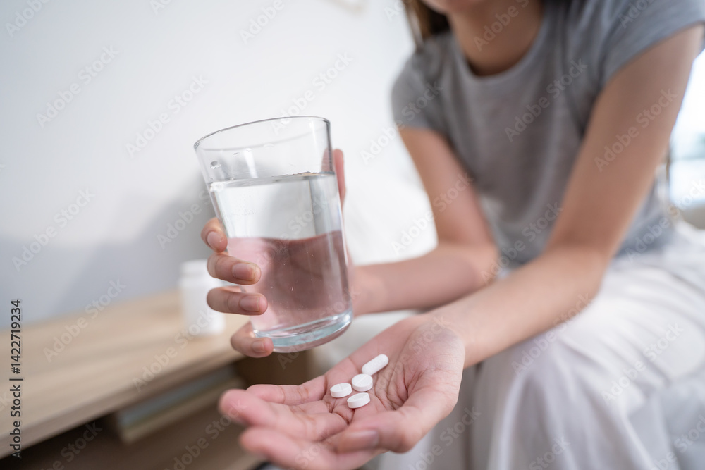 Close up hands of sick woman taking a medicine after wake up on bed. Close up hands of sick woman taking a medicine after wake up on bed.