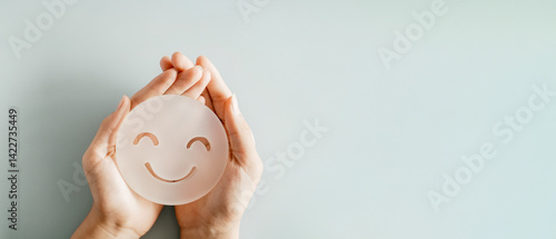Fotografie hand holding smile face, happy hormones, brain chemicals, positive mental health