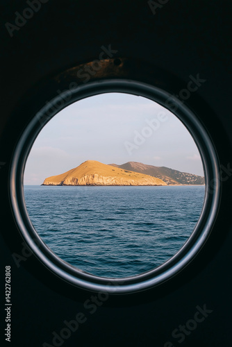 A view of the ocean from a small window