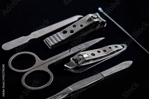 Obraz na płótnie Set of nail care tools for health and beauty isolated on black background. A set of tools for Manicure and pedicure care w salonie