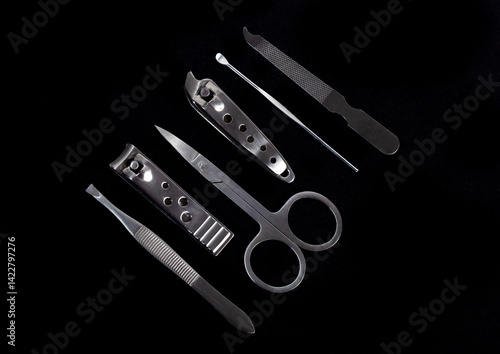 Obraz na płótnie Set of nail care tools for health and beauty isolated on black background. A set of tools for Manicure and pedicure care w salonie