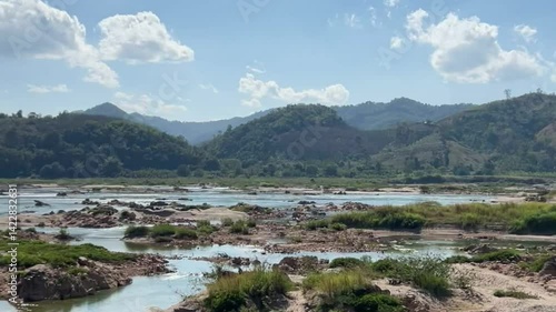Mekong river in summer seeing rocks and beach with mountain background at Sangthong, Vientiane, Laos country, Beautiful of natural in laos.	