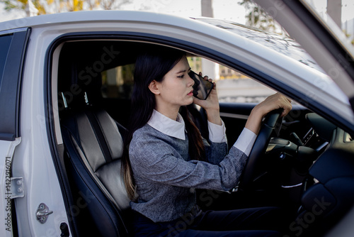 A woman is talking on the phone while driving.