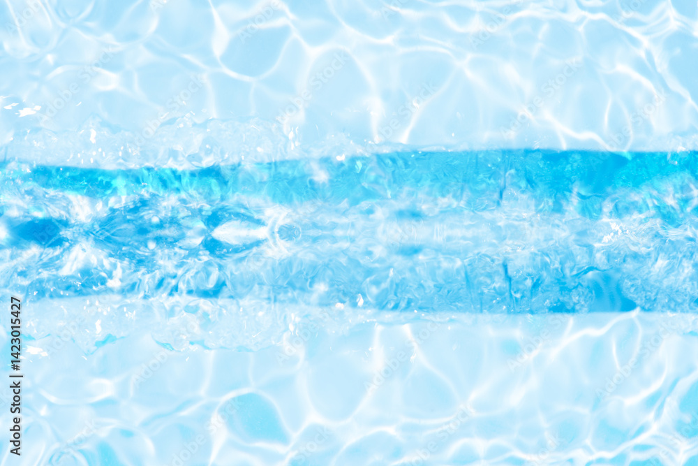 Obraz premium Blue water with ripples on the surface. Defocus blurred transparent blue colored clear calm water surface texture with splashes and bubbles. Water waves with shining pattern texture background.