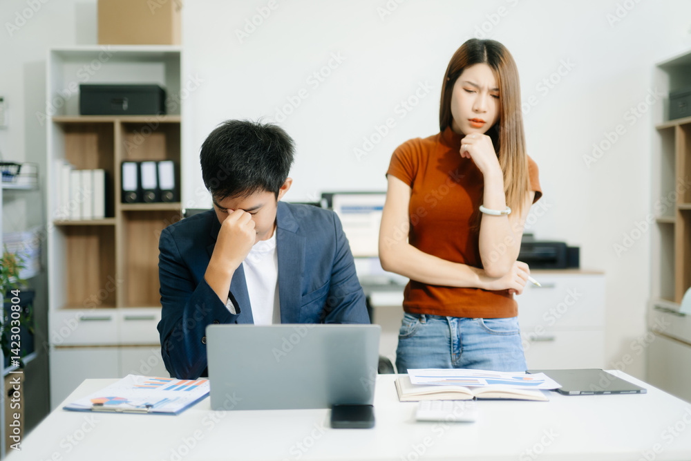 Furious two Asian businesspeople arguing strongly after making a mistake at work Furious two Asian businesspeople arguing strongly after making a mistake at work