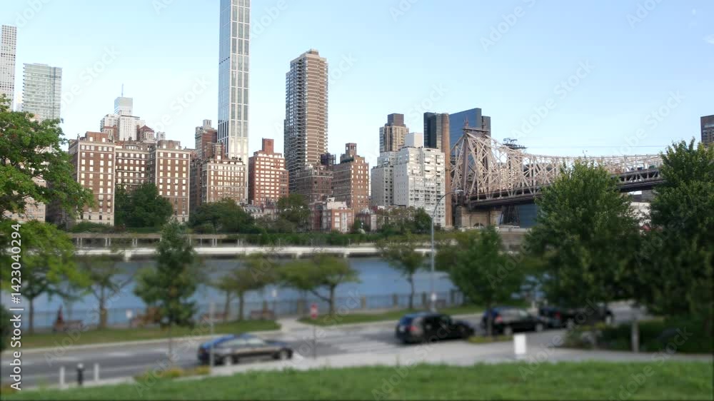 New York City waterfront skyline, Queensboro Bridge, Manhattan Midtown buildings, riverfront skyscrapers. Waterside cityscape view from Roosevelt Island. United States architecture and real estate.