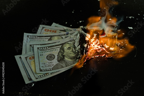 Stack banknote is burning on a black background