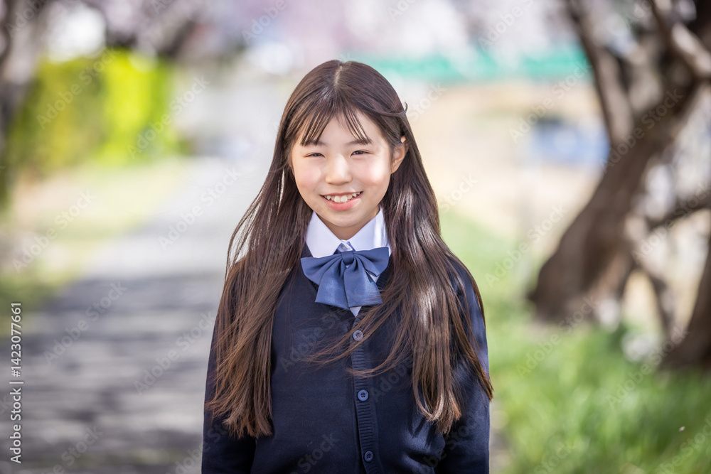 桜の下で微笑む学生