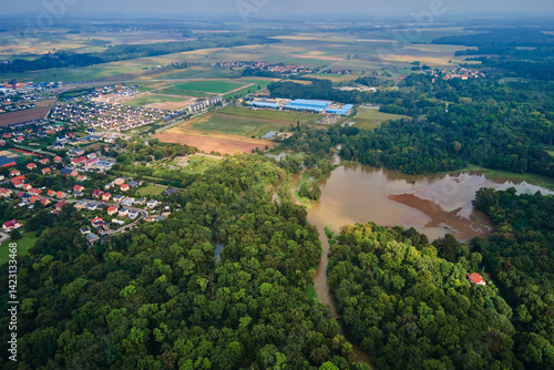 Obraz na płótnie Aerial view of flooded landscape with rural village, farmlands and forest. Natural disaster w salonie