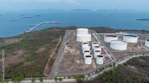 Obraz na płótnie Oil terminal industrial facility storage tank, Oil storage tank with oil terminal port loading arm cargo oil product tanker ship, Global business refinery industry commercial port. w salonie