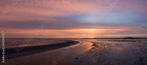 Sunset view of Waddensea, mudflats at low tide on Pinkewad, south of Ameland, Friesland, Netherlands