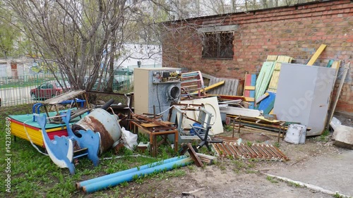 Garbage and home appliances parts in waste. junkyard. Old Unwanted Household Furniture and other things Dumped for Curbside Pickup by City Garbage Collection Cleaning Services. waste in dump yard