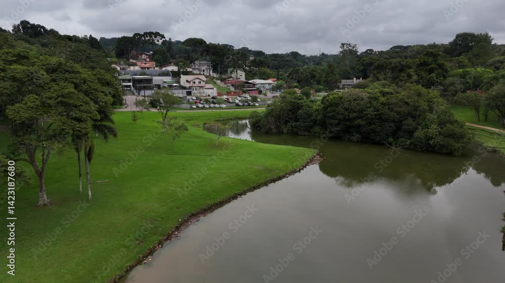 Aerial view of Parque São Lourenço in Curitiba – drone footage over Rio Belém with lush trees on a cloudy day in southern Brazil Aerial view of Parque São Lourenço in Curitiba – drone footage over Rio Belém with lush trees on a cloudy day in southern Brazil