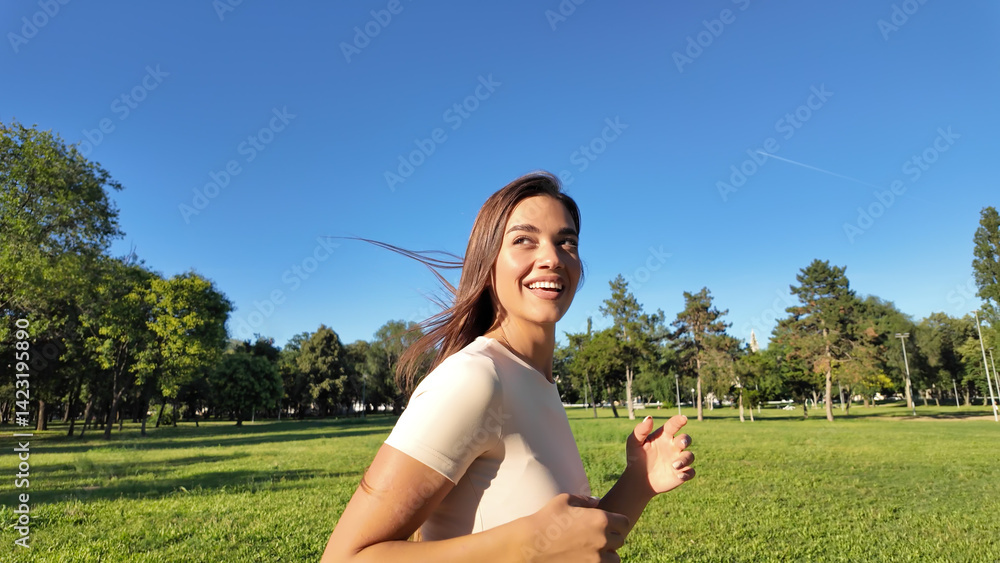 Young woman running and jogging in urban park.