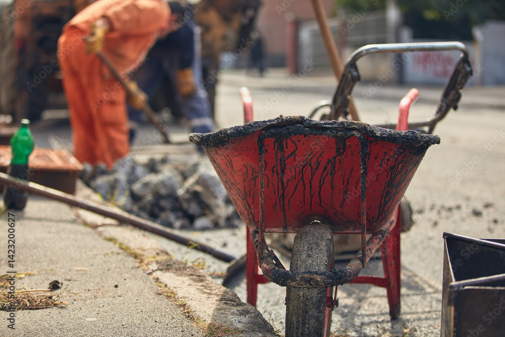 Construction workers working on a public city street reconstruction.