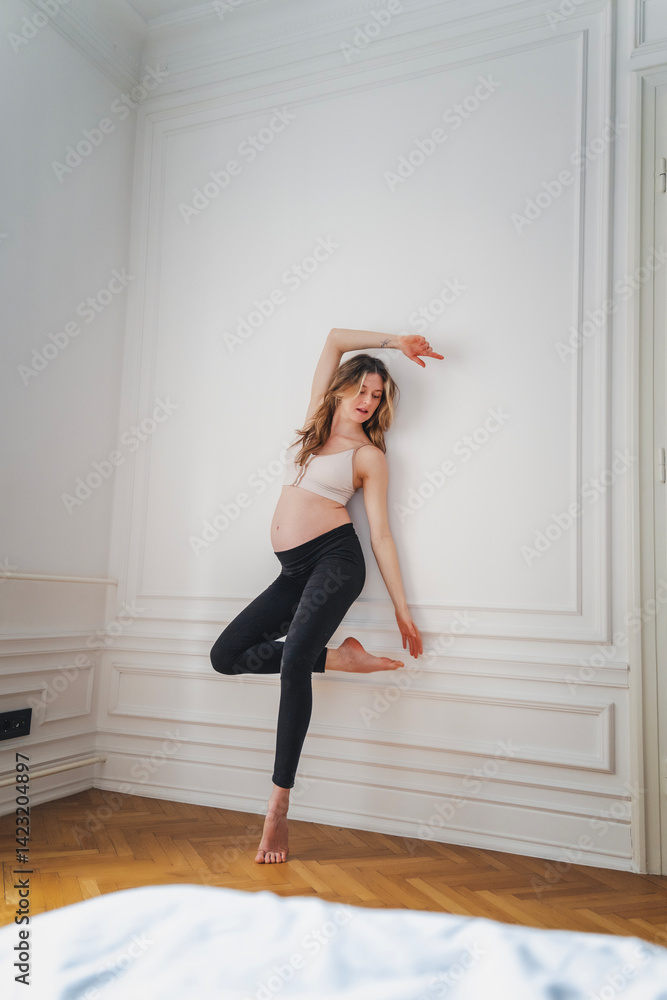 Young attractive pregnant woman dancing, grace conscious movement choreography concept