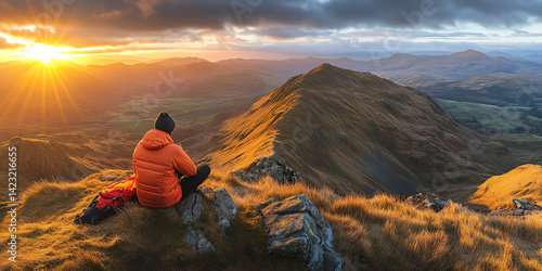Photography A lone hiker sits atop a mountain, enjoying a breathtaking sunset over vast valleys