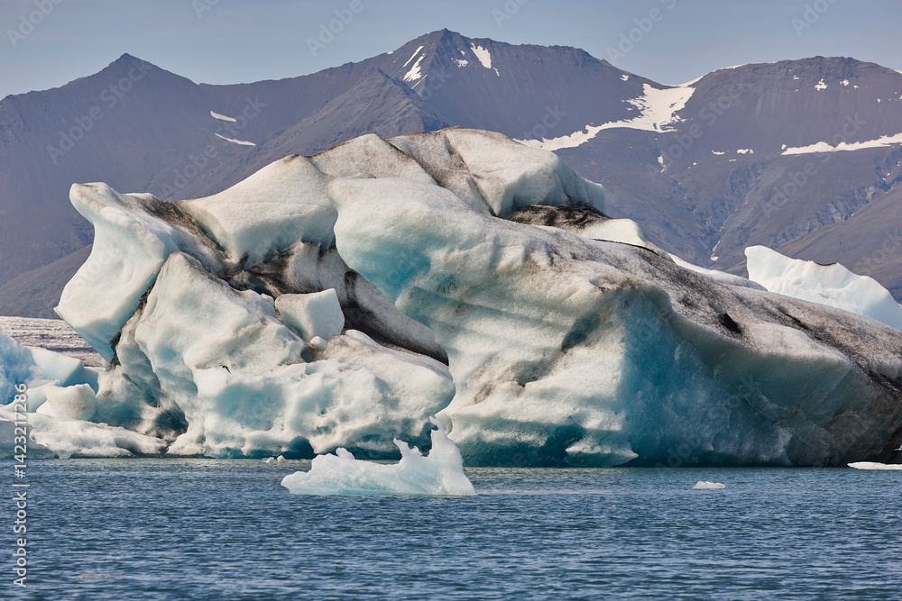 Icebergs turquoise lake and snowy mountains. Jokulsarlon, Southeast area. Iceland.