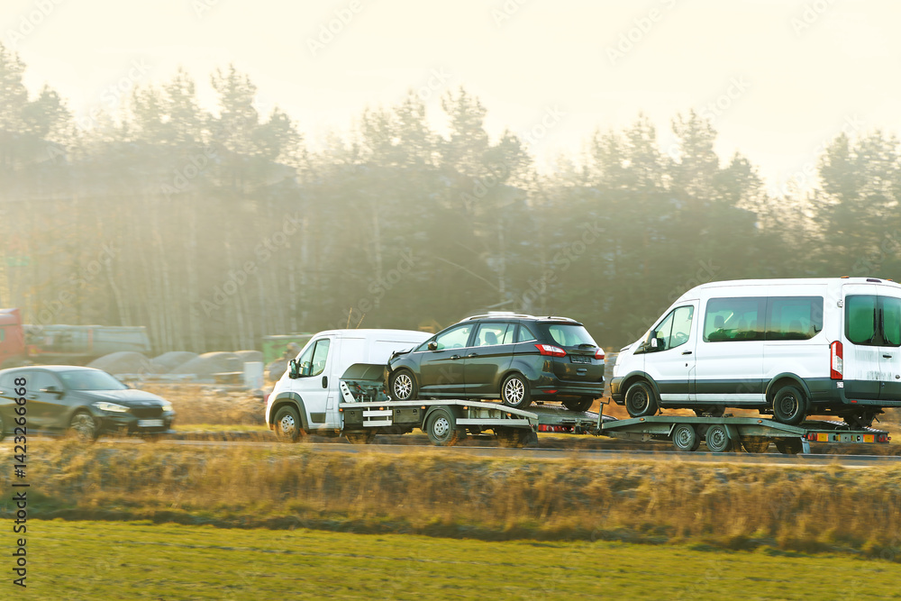 Tow truck transporting car after breakdown