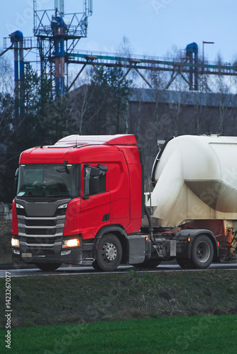 Obraz na płótnie Red semi-truck pulling a white cylindrical tanker w salonie