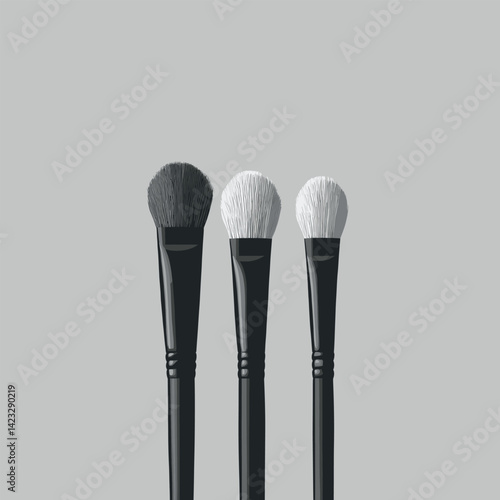 Set of three makeup brushes with black and white bristles on gray background
