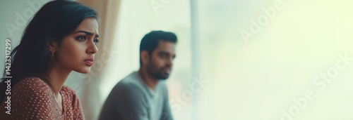 Obraz na płótnie Indian couple having domestic scandal, upset young wife and husband turned away and ignoring each other w salonie