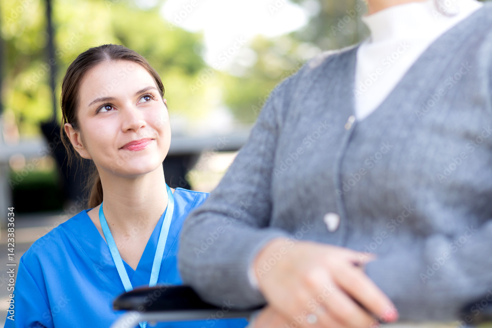 Young caucasian nurse comforting with patient while sitting on wheelchair in outdoor park, doctor woman support and counseling with patient, caregiver and service with senior, medical and consoling. Young caucasian nurse comforting with patient while sitting on wheelchair in outdoor park, doctor woman support and counseling with patient, caregiver and service with senior, medical and consoling.