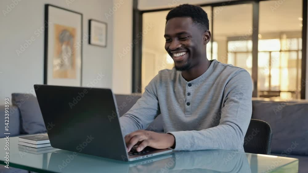 Young man working on laptop in modern home office Young man working on laptop in modern home office