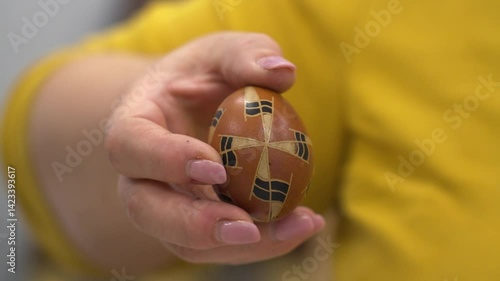 Wallpaper Mural A hand holds a traditional Hungarian Easter egg with geometric wax patterns Torontodigital.ca