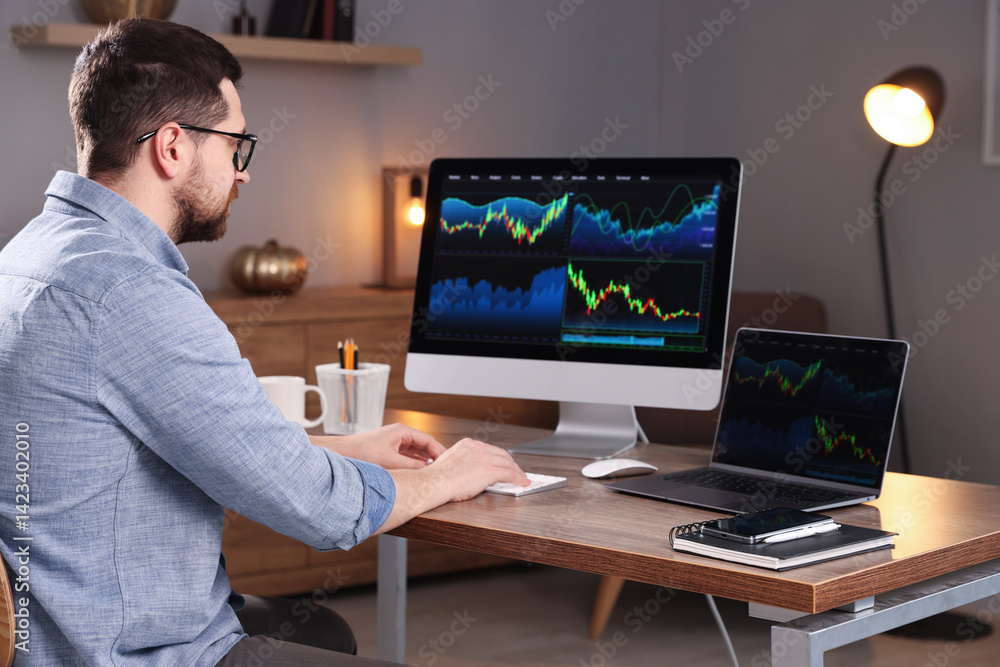 Stock exchange. Man analysing financial market on computer at desk indoors Stock exchange. Man analysing financial market on computer at desk indoors