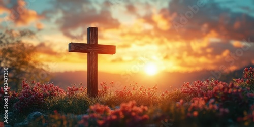 Sunset view of a cross surrounded by flowers in a serene landscape with vibrant sky colors