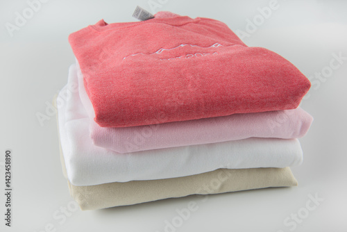 sweatshirts in different colors and designs stacked on top of each other