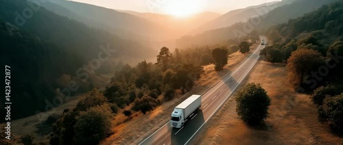 truck on the highway transporting goods.  delivering freight while traversing the mountains on an asphalt road.  as seen from above.  landscape as seen from above.  filmmaking with a drone