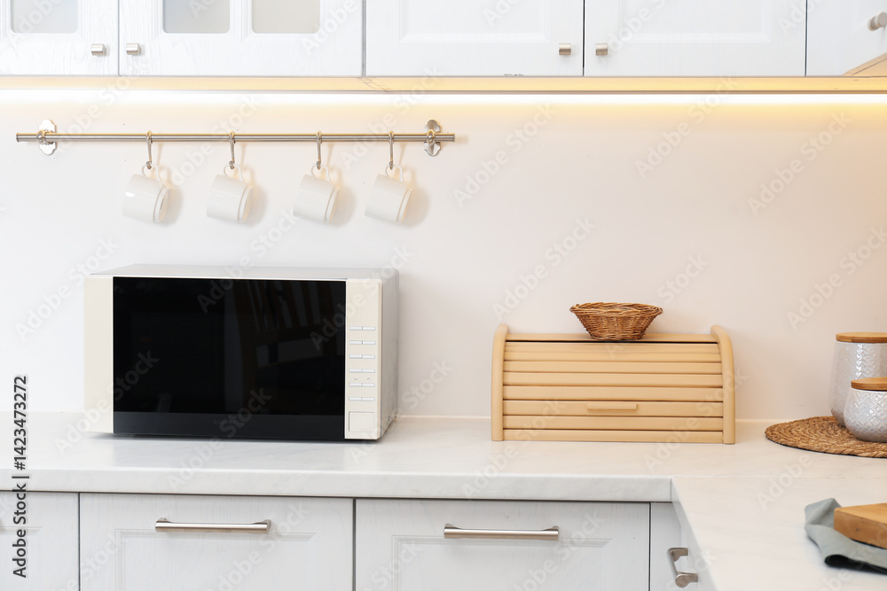 Closed microwave oven on counter in kitchen Closed microwave oven on counter in kitchen