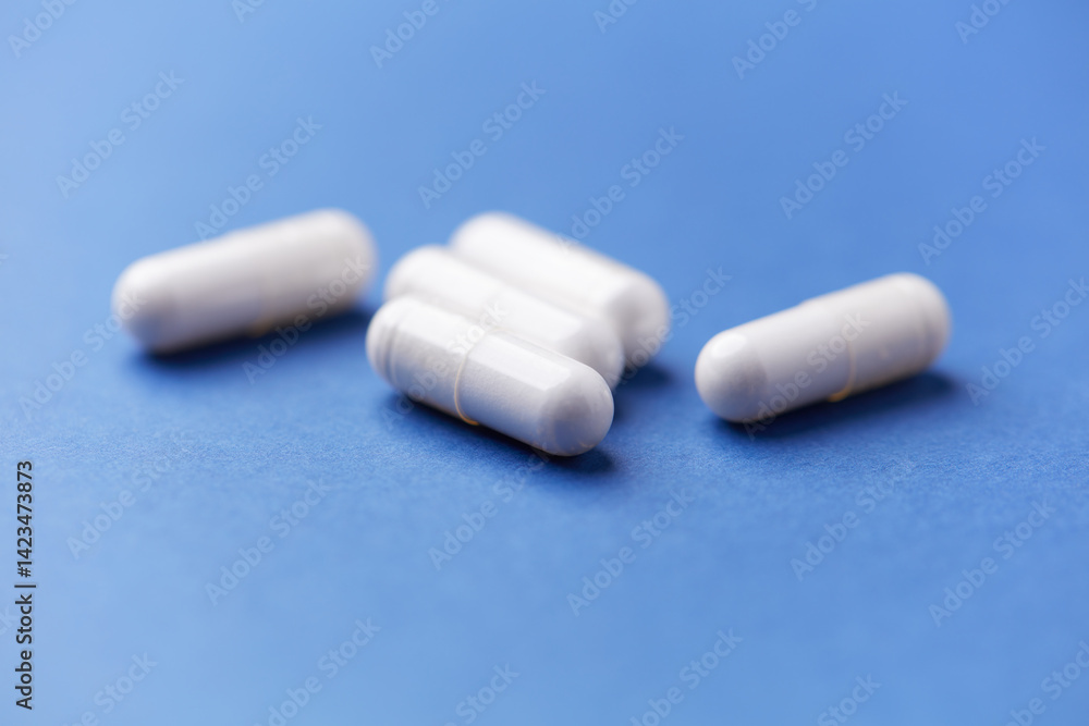 Arginine capsules on bright wooden background. Soft focus. Close up. Copy space. Arginine capsules on bright wooden background. Soft focus. Close up. Copy space.