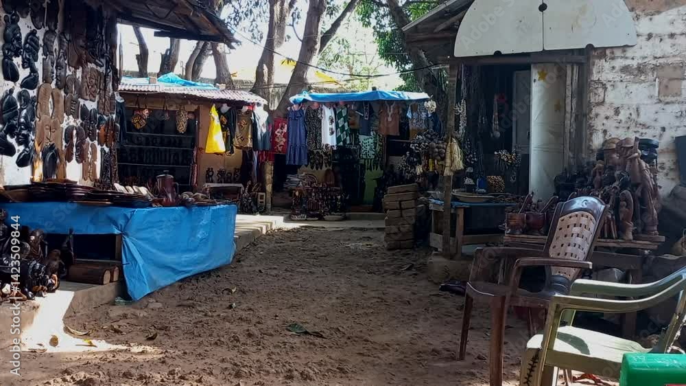 Craft market in Guinea Bissau with wooden sculptures and colorful cloth dresses Craft market in Guinea Bissau with wooden sculptures and colorful cloth dresses