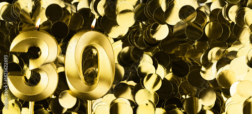 фотографія Golden number thirty candle on shiny yellow confetti background