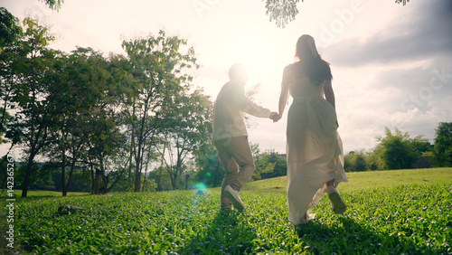 Canvastavla Back rear view young lover asia people happy smile trust hold hand enjoy relax walk way forward to sun light