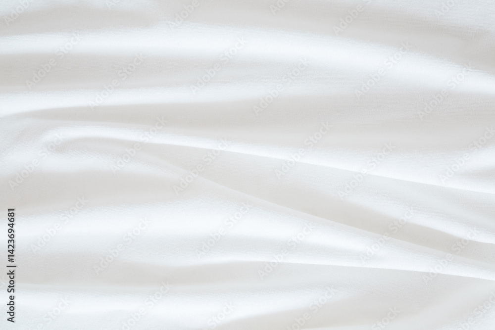 Obraz premium White wavy bed sheet background. Closeup. Top down view.