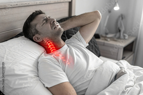 man suffering from neck pain from bad night sleep