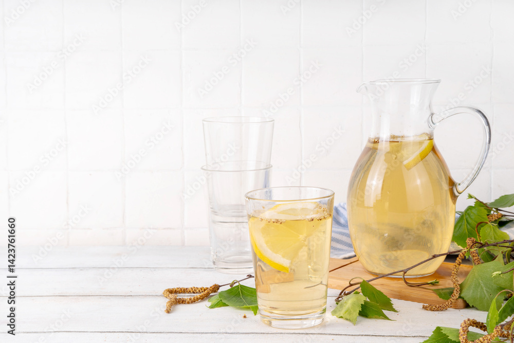 Fototapeta premium Cold birch tea, birch sap summer refreshment drink with honey and lemon. Infused detox beverage
