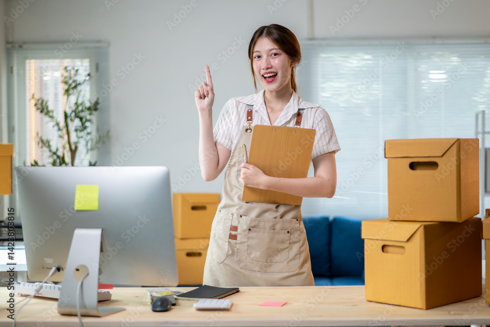 A woman is standing in front of a desk with a computer monitor and a clipboard A woman is standing in front of a desk with a computer monitor and a clipboard