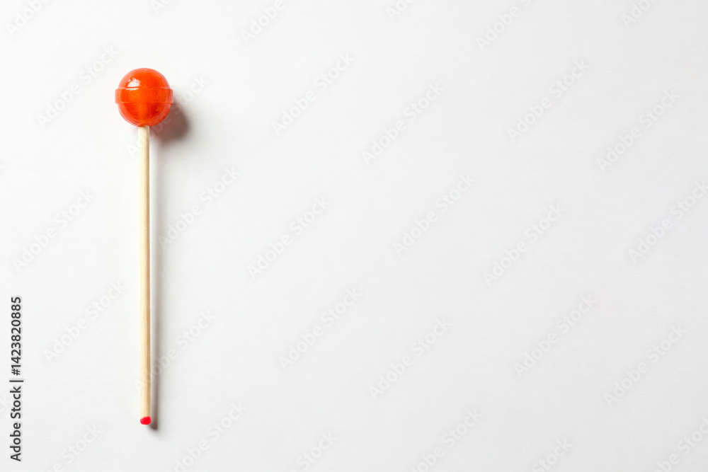 Red lollipop on a light background. Space for text. Red lollipop on a light background. Space for text.