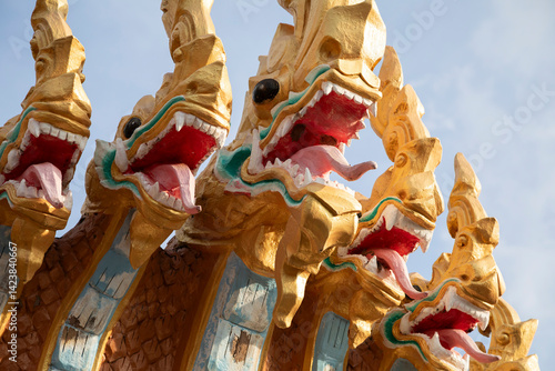 фотографія Painted statues of Nagas near Wat Phousalao temple in Pakse, Laos, Champasak