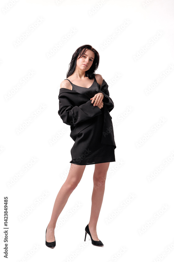 Model poses confidently in black attire with minimalist background showcasing contemporary fashion aesthetics Model poses confidently in black attire with minimalist background showcasing contemporary fashion aesthetics