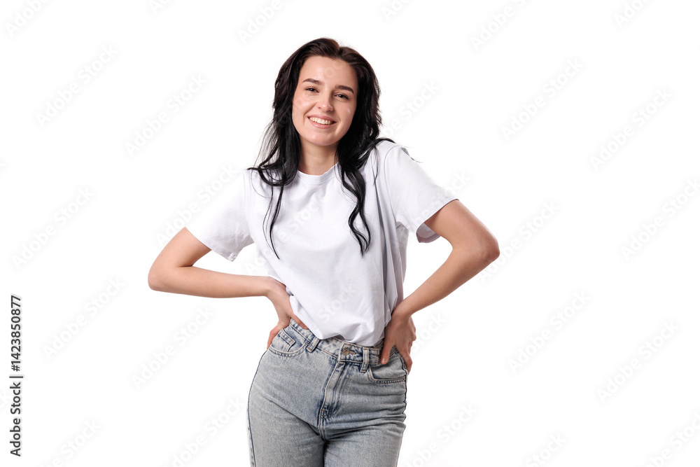 Young woman poses confidently in casual outfit with white t-shirt and blue jeans in studio setting Young woman poses confidently in casual outfit with white t-shirt and blue jeans in studio setting