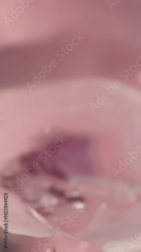 Wallpaper Mural Thirsty person drinks sweet pink beverage from plastic bottle using nipple for comfortable drinking. Tasty beverage. View from container inside macro Torontodigital.ca