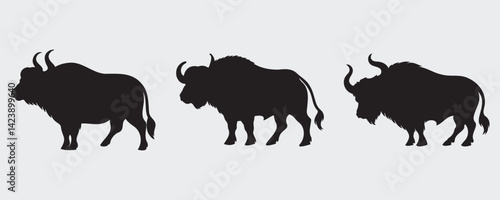 Silhouettes of three powerful buffalo with distinct horns and shaggy bodies, shown in varied poses on a light background
