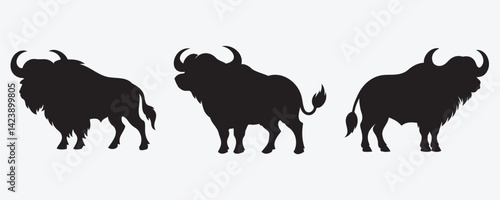Silhouettes of three powerful buffalo with distinct horns and shaggy bodies, shown in varied poses on a light background